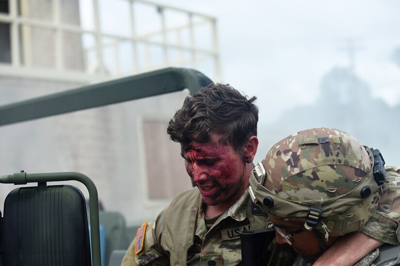 An Army Reserve Soldier from the 851st Transportation Company moves a simulated injured Soldier out of a vehicle during the first inject of the Home State Training Lanes at CSTX 86-22-02 on Fort McCoy, Wisconsin, August 15, 2022.
