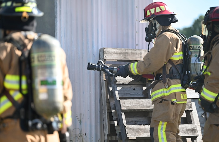 a man prepares to extinguish a fire.