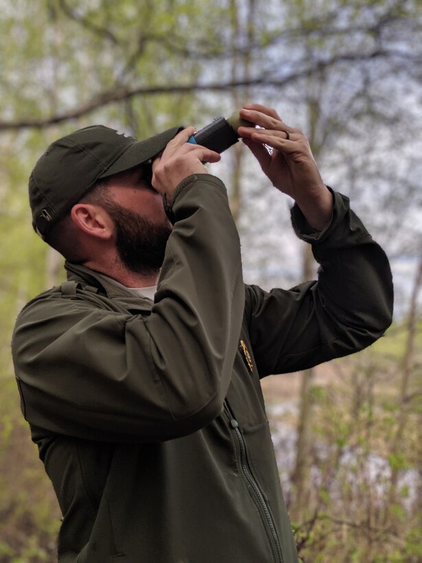 Justin Kerwin, senior park ranger, candles a common goldeneye duck egg to check its intubation stage at the Chena River Lakes Flood Control Project in North Pole, Alaska. Working with officials for the U.S. Fish and Wildlife Service and U.S. Army Corps of Engineers – Alaska District park rangers at the Chena Project, students track bird species that use the nest boxes and tag chicks that hatch. The students must monitor and time their visits to the boxes to ensure they tag and catalog each chick before they leave the nest as there is only about a 24-hour window to attach a small metal web tag to each duckling before they leap out of the box and head for the nearest water body. (U.S. Fish and Wildlife Service courtesy photo)