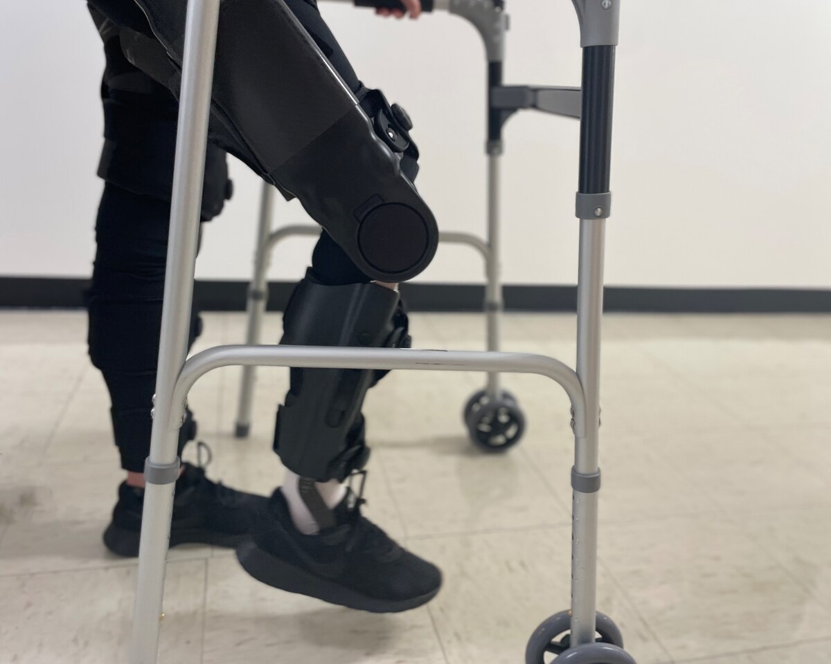 U.S. Air Force Airman 1st Class Lauren Arduser, 311th Training Squadron Russian language analyst, walks with the help of a powered exoskeleton at the St. Louis VA Healthcare System-Jefferson Barracks, Missouri, August 19, 2022. The powered exoskeleton helps stabilize body movement and increases Arduser’s leg muscles and cardiovascular endurance. (U.S. Air Force photo by Senior Airman Abbey Rieves)