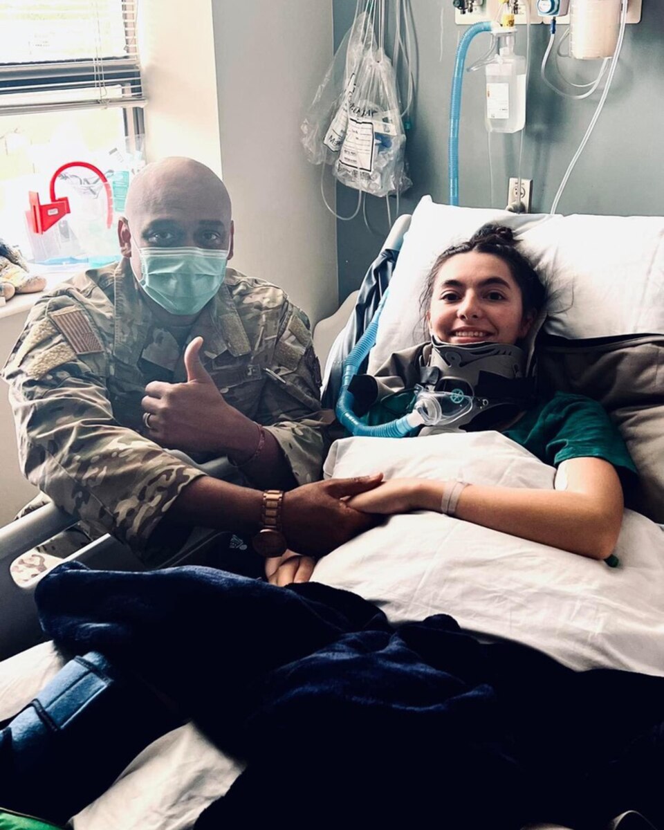 U.S. Air Force Lt. Col. E.J. Mason, 316th Training Squadron commander, visits Airman 1st Class Lauren Arduser, 311th Training Squadron Russian language analyst, in the hospital after a life-threatening car accident, San Angelo, Texas, March n.d., 2022. Arduser was a Russian language analyst, TDY to Goodfellow Air Force Base, Texas, from Presidio of Monterey, California, for intelligence training. (Courtesy Photo)
