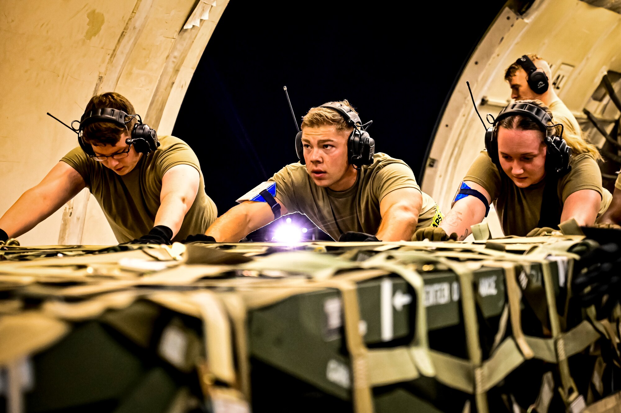 Airmen assigned to the 305th Aerial Port Squadron upload Guided Multiple Launch Rocket System munitions onboard a Boeing 767 at Joint Base McGuire-Dix-Lakehurst, N.J., Aug. 11, 2022. The munitions cargo is part of an additional security assistance package for Ukraine. The security assistance the U.S. is providing to Ukraine is enabling critical success on the battlefield against the Russian invading force. (U.S. Air Force photo by Senior Airman Matt Porter)