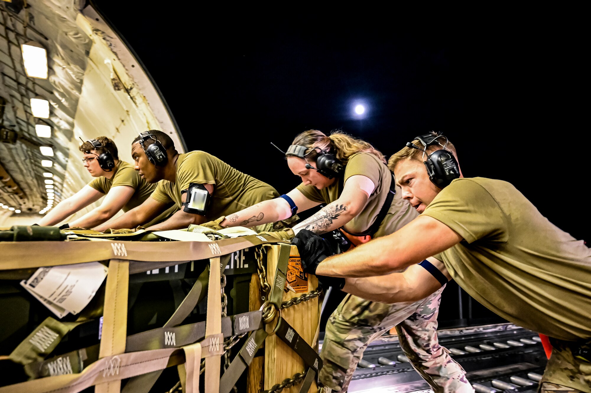 Airmen assigned to the 305th Aerial Port Squadron, upload Guided Multiple Launch Rocket System munitions onboard a Boeing 767 at Joint Base McGuire-Dix-Lakehurst, N.J., Aug. 11, 2022. The munitions cargo is part of an additional security assistance package for Ukraine. The security assistance the U.S. is providing to Ukraine is enabling critical success on the battlefield against the Russian invading force. (U.S. Air Force photo by Senior Airman Matt Porter)