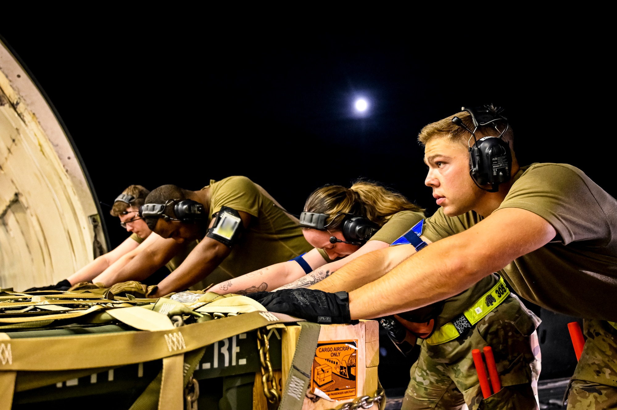 Airmen assigned to the 305th Aerial Port Squadron, upload Guided Multiple Launch Rocket System munitions onboard a Boeing 767 at Joint Base McGuire-Dix-Lakehurst, N.J., Aug. 11, 2022. The munitions cargo is part of an additional security assistance package for Ukraine. The security assistance the U.S. is providing to Ukraine is enabling critical success on the battlefield against the Russian invading force. (U.S. Air Force photo by Senior Airman Matt Porter)