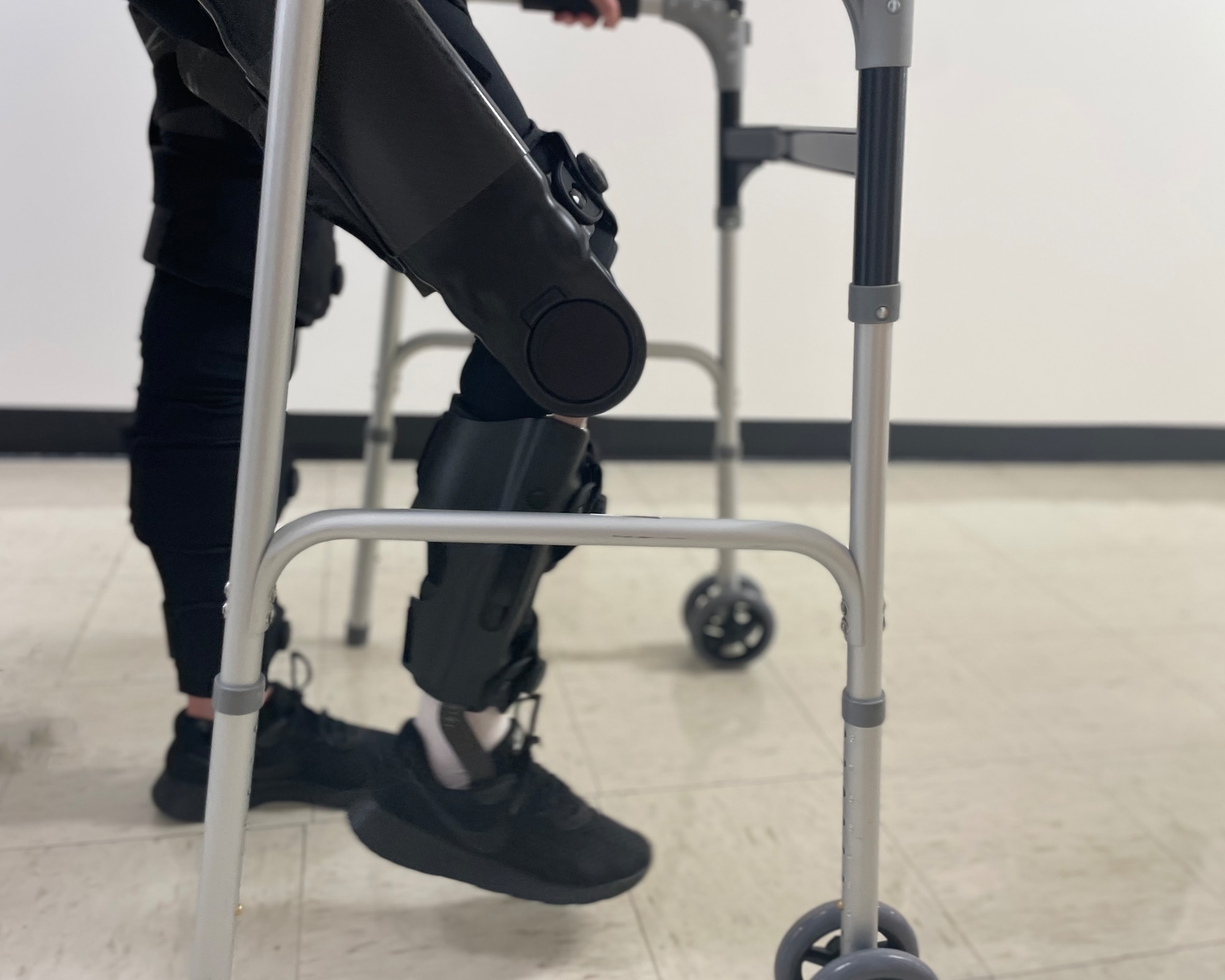 U.S. Air Force Airman 1st Class Lauren Arduser, 311th Training Squadron Russian language analyst, walks with the help of a powered exoskeleton at the St. Louis VA Healthcare System-Jefferson Barracks, Missouri, August 19, 2022. The powered exoskeleton helps stabilize body movement and increases Arduser’s leg muscles and cardiovascular endurance. (U.S. Air Force photo by Senior Airman Abbey Rieves)