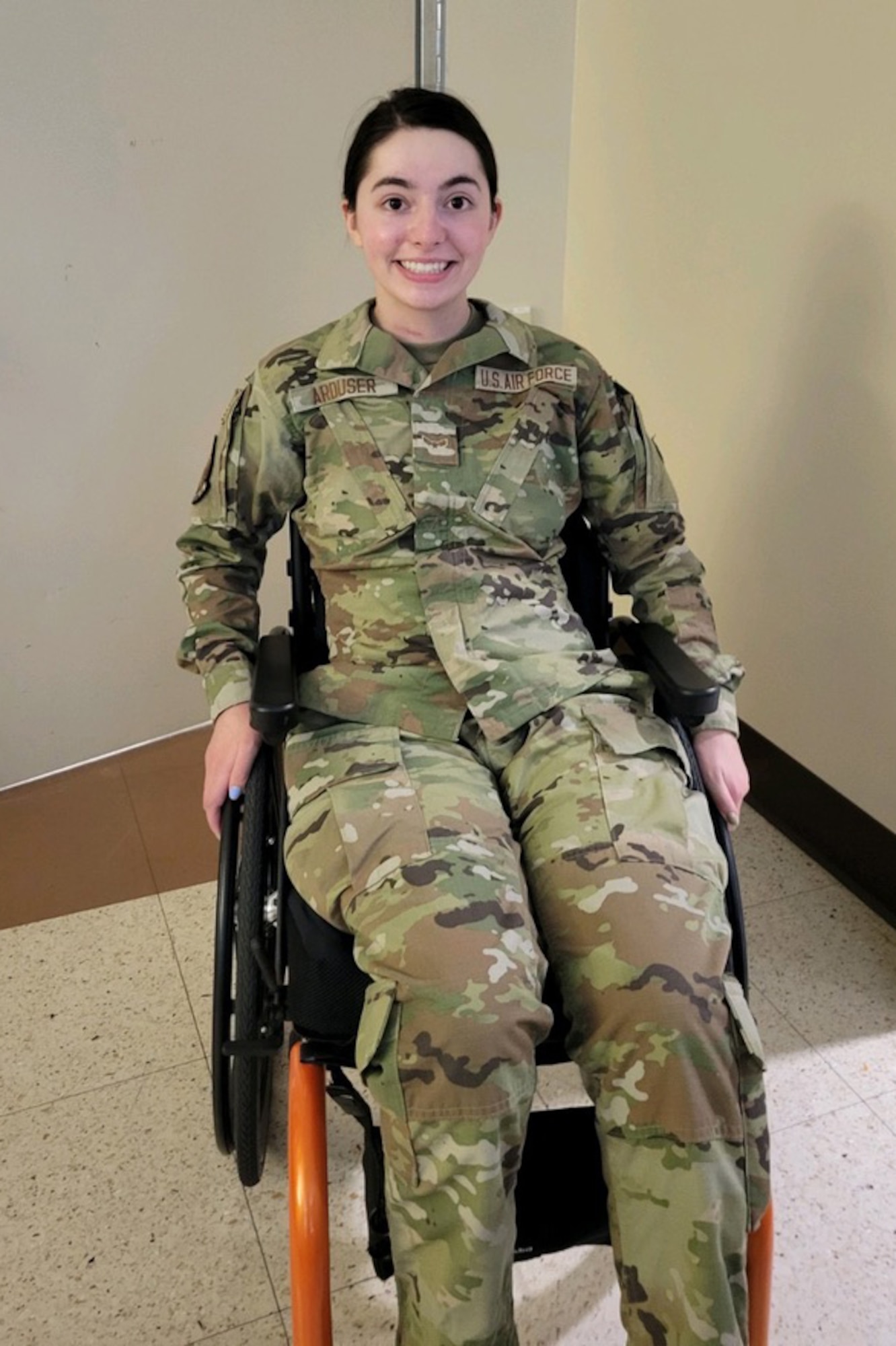 U.S. Air Force Airman 1st Class Lauren Arduser, 311th Training Squadron Russian language analyst, celebrates putting her uniform on independently, at the St. Louis VA Healthcare System-Jefferson Barracks, Missouri, May, n.d., 2022. Arduser was expected to die from a quadriplegic injury, but can now move every limb. She fights each day to be better and does more, so she can return to the mission. (Courtesy Photo)