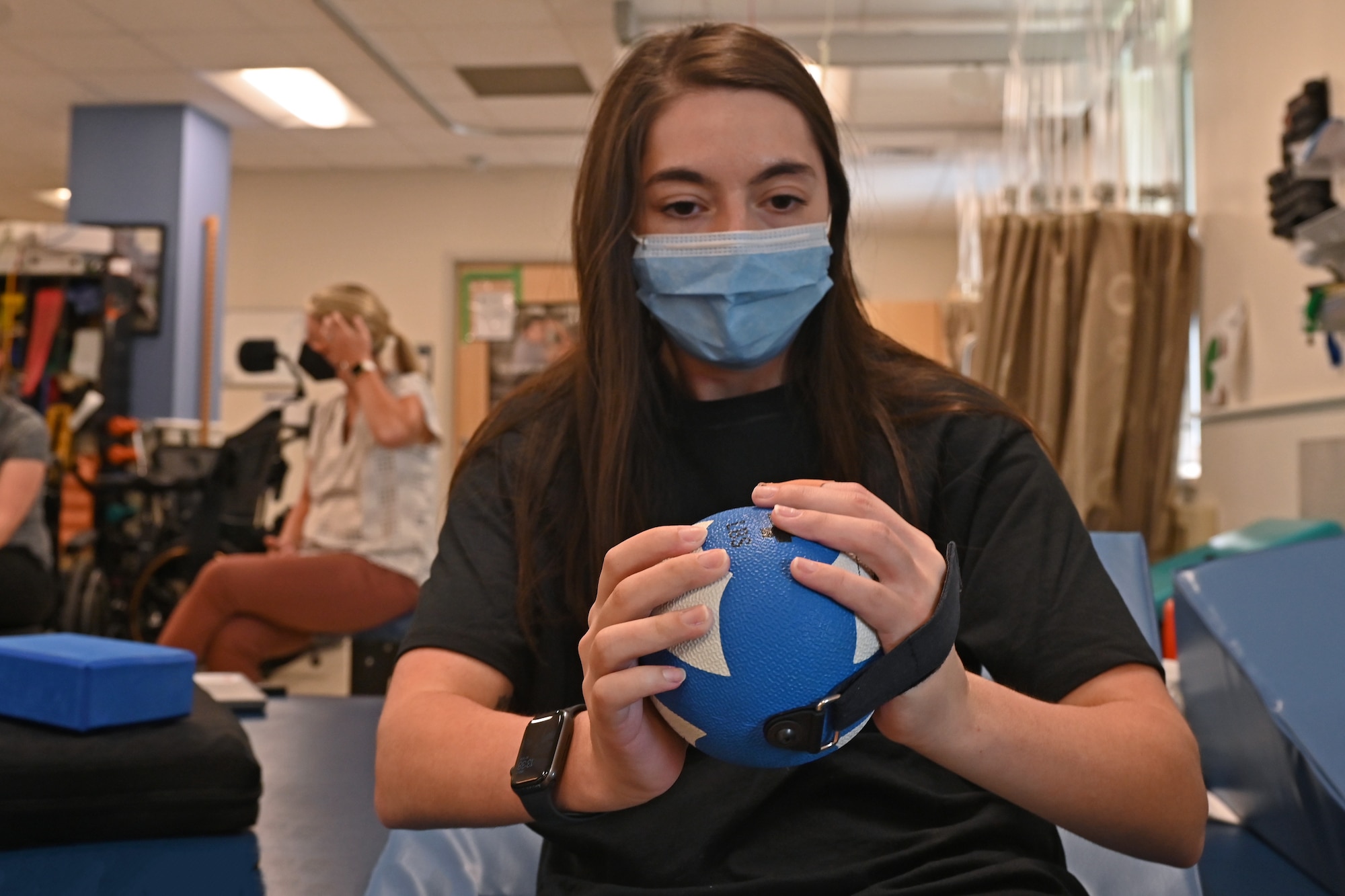 U.S. Air Force Airman 1st Class Lauren Arduser, 311th Training Squadron Russian language analyst, performs weighted sit-ups for her physical therapy, at the St. Louis VA Healthcare System-Jefferson Barracks, Missouri, August 17, 2022. Arduser suffered a spinal cord injury in a car accident and worked to rebuild her lost core muscle function required for functional movements. (U.S. Air Force photo by Senior Airman Abbey Rieves)
