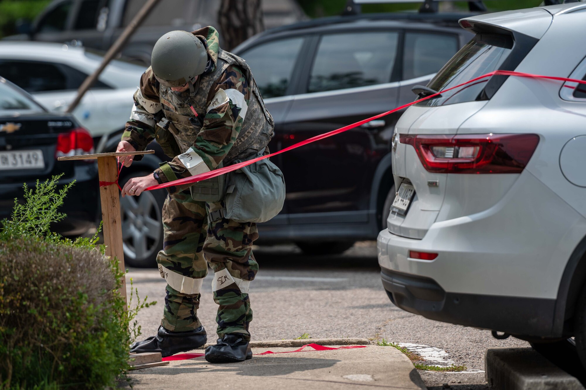 Tech. Sgt. KC Ratekin, 51st Comptroller Squadron financial analysis supervisor, sets up a perimeter around a simulated unexploded ordnance (UXO) during a base-wide training event at Osan Air Base