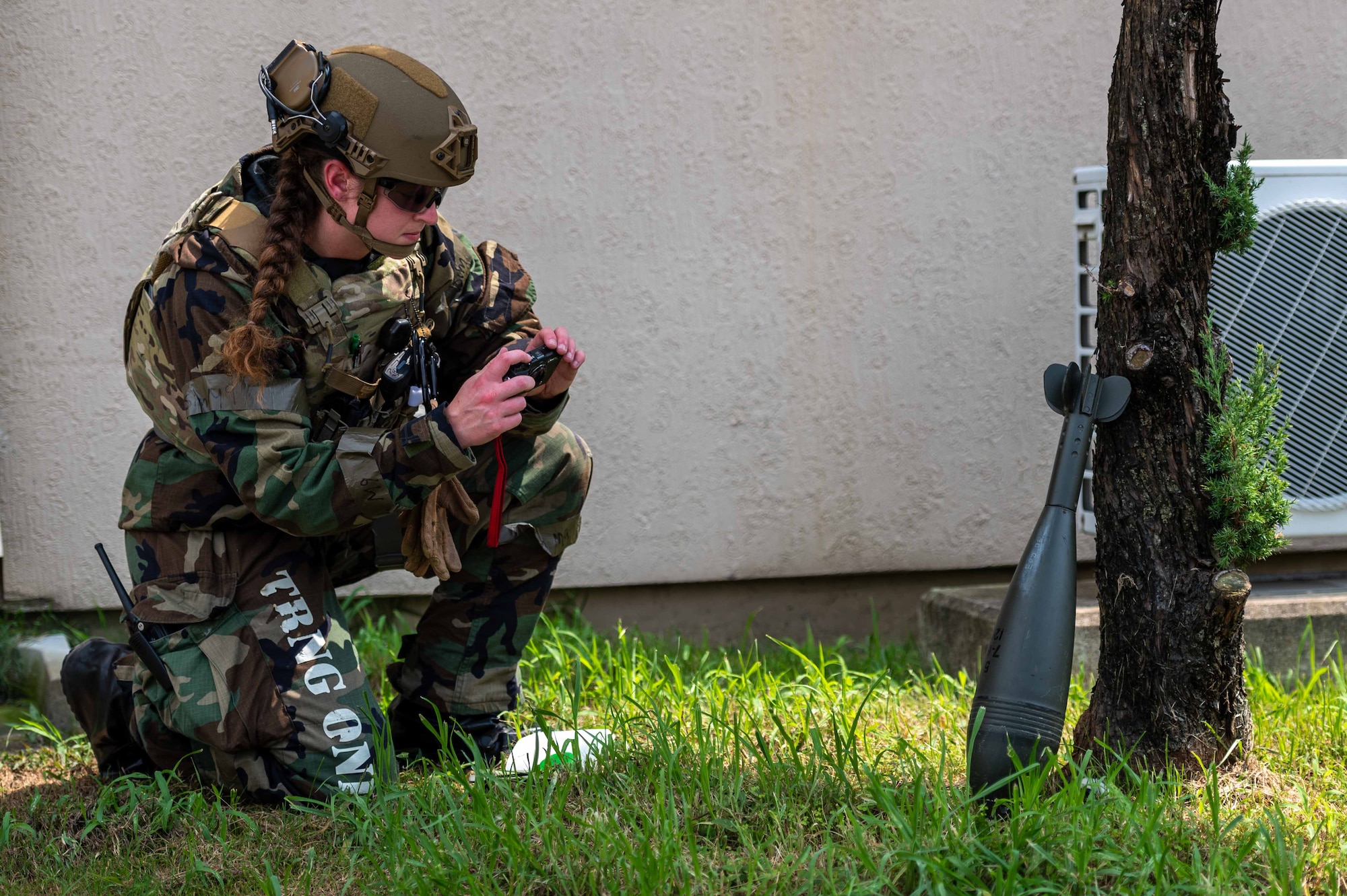 Senior Airman Janie Roberts, 51st Civil Engineer Squadron explosive ordnance disposal (EOD) team lead, takes photos and annotates the description of a simulated unexploded ordnance (UXO) during a base-wide training event at Osan Air Base