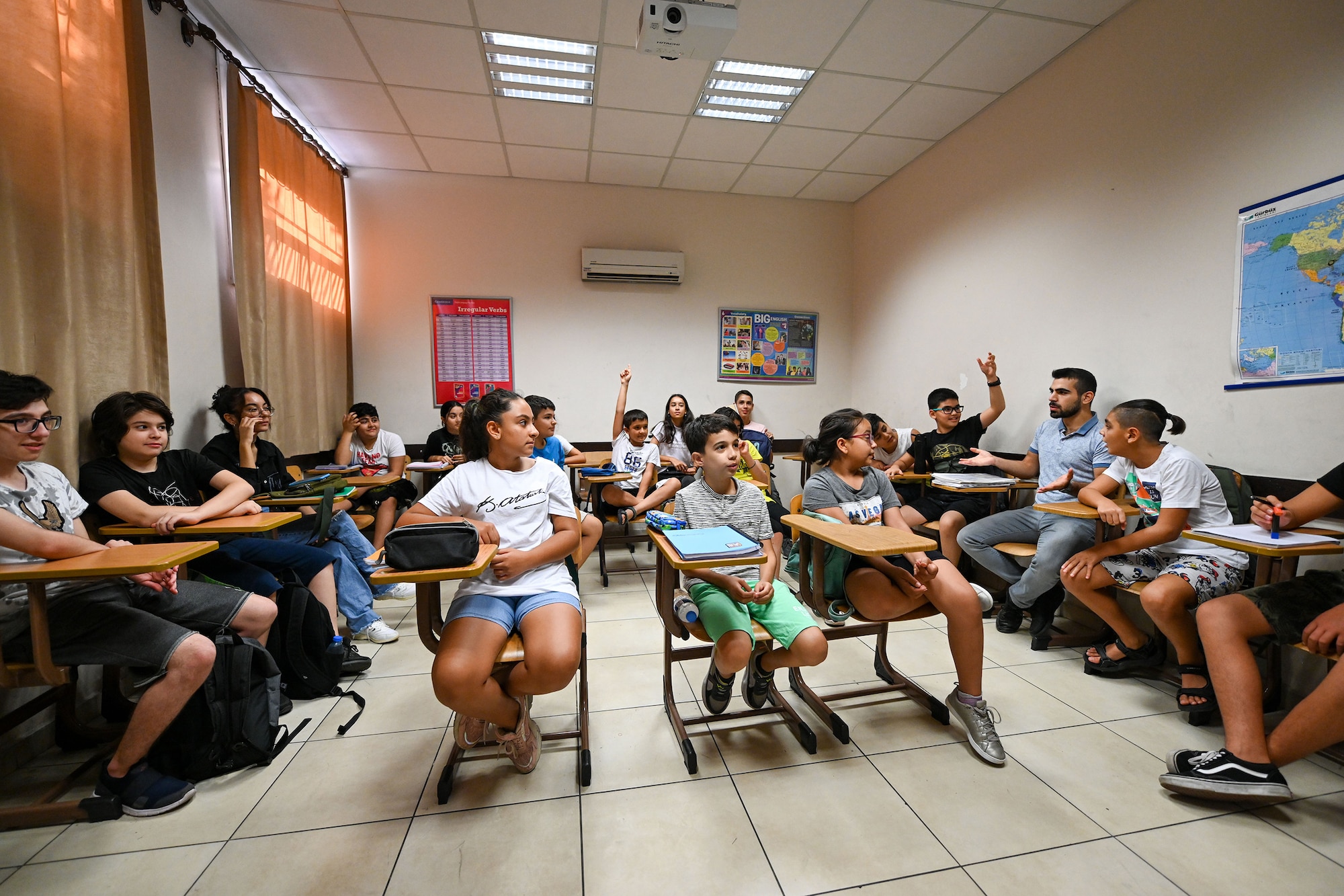 Students in the Turkish-American Association (TAA) participate in a presentation with Airman Leadership School (ALS) Airmen assigned to the 39th Air Base Wing (ABW) at the TAA building in Adana, Turkey, Aug. 23, 2022.
