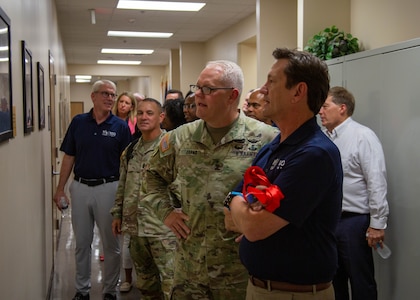 U.S. Army Lt. Gen. John R. Evans, U.S. Army North commanding general, Command Sgt. Maj. Phil K. Barretto, senior enlisted advisor, cut the ribbon with Wayne Peacock, president and chief executive of USAA, to celebrate the relationship with USAA and the U.S. Army at Building 44 on Joint-Base San Antonio-Fort Sam Houston, Texas, Aug.18, 2022. The ceremony honored USAA’s historical roots among the local San Antonio, Texas community and celebrated the long-standing partnership with U.S. Army North in connection to the building. (U.S. Army photo by Pfc. Gianna Elle Sulger)