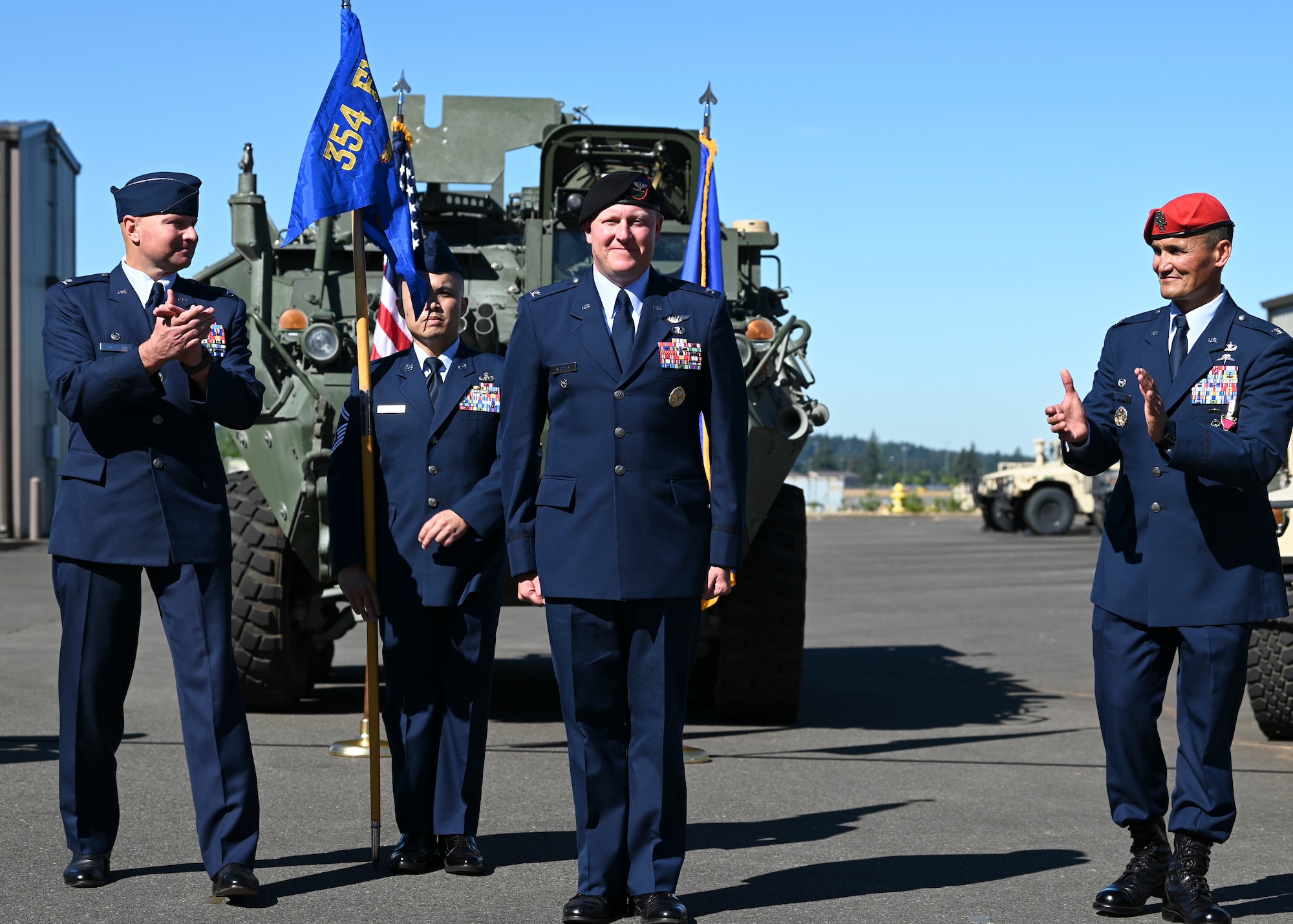 U.S. Air Force Col. David Berkland, left, commander of the 354th Fighter Wing, and Col. Travis Woodworth, right, outgoing commander of the 1st Air Support Operations Group, clap for Col. John Blocher, incoming commander of the 1st ASOG, as he assumes command of the 1st ASOG, during a change of command ceremony at Joint Base Lewis-McChord, Washington, August 15, 2022. The 1st ASOG provides an Air Support Operations Center, Tactical Air Control Parties and Battlefield Weather Teams to Army combat units at multiple echelons including United States Army Pacific, I Corps, and nine aviation, airborne, infantry and Stryker brigade combat teams of the 2nd and 25th Infantry Divisions. (U.S. Air Force photo by Senior Airman Callie Norton)