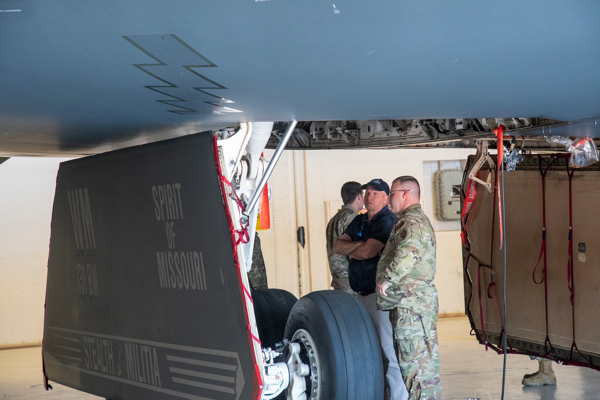 U.S. Air Force Master Sgt. Justin Petree, 131st Bomb Wing crew chief, talks shop with Master Sgt. Kieth Meadows during a tour of the B-2 Spirit stealth bomber at Whiteman Air Force Base, Missouri, Aug. 10, 2022. Meadows was the first dedicated crew chief for tail number 80329, the Spirit of Missouri, from 1991-1996, and Petree is the current dedicated crew chief for the aircraft. (U.S. Air National Guard photo by Master Sgt. John Hillier)