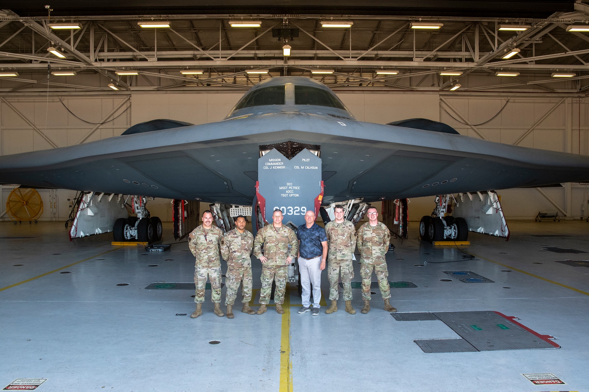 Former U.S. Air Force Master Sgt. Kieth Meadows poses for a photo with 131st Bomb Wing crew chiefs during a visit to Whiteman Air Force Base, Missouri, Aug. 10, 2022. Meadows was the first dedicated crew chief for B-2 Spirit stealth bomber number 80-329, the Spirit of Missouri, from 1991-1996, and met with the aircraft’s current maintenance team during his visit. (U.S. Air National Guard photo by Master Sgt. John Hillier)