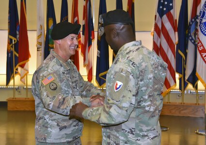 Col. Ryan Bailey, left, outgoing commander of the U.S. Army Medical Materiel Agency, shakes hands with Col. Tony Nesbitt, commander of U.S. Army Medical Logistics Command, during a change of command ceremony Aug. 19 at Fort Detrick, Maryland. Bailey, who will retire in September after more than 30 years of service, relinquished command to Col. Gary Cooper. The ceremony also served as an assumption of responsibility for Sgt. Maj. Hugo Roman, USAMMA’s new senior enlisted leader.