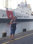 Lisa Parks in front of Coast Guard Cutter 37 (formerly Coast Guard Cutter Taney) on Pier 5 of Baltimore’s Inner Harbor.  Parks, who works at the nearby Surface Forces Logistics Center (SFLC) as chief of the Information Services Branch, began her Coast Guard career 33 years ago as a high school intern.