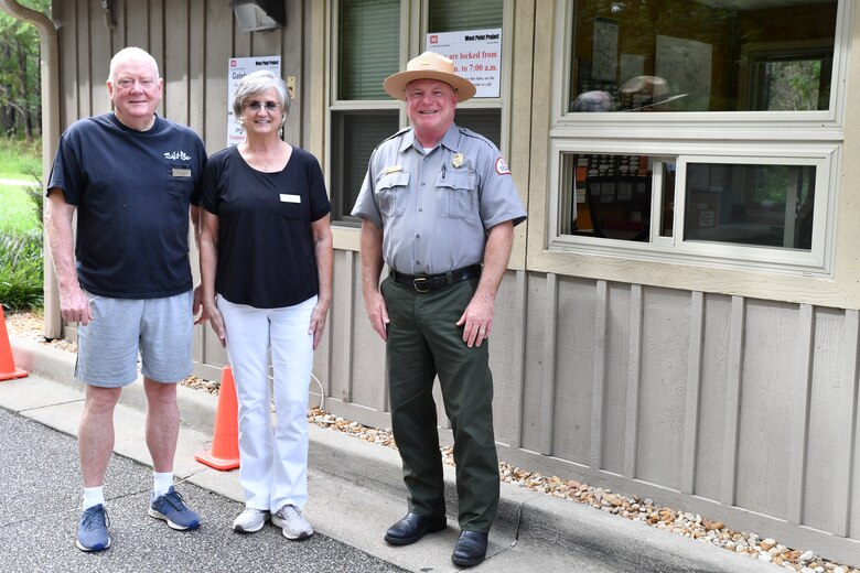 David Barr, Chief Ranger at the West Point Project, poses with a couple of gatehouse volunteers on August 10, 2022, in Georgia. Barr has worked for West Point since 1992, said he will miss interacting with people when he retires in December.