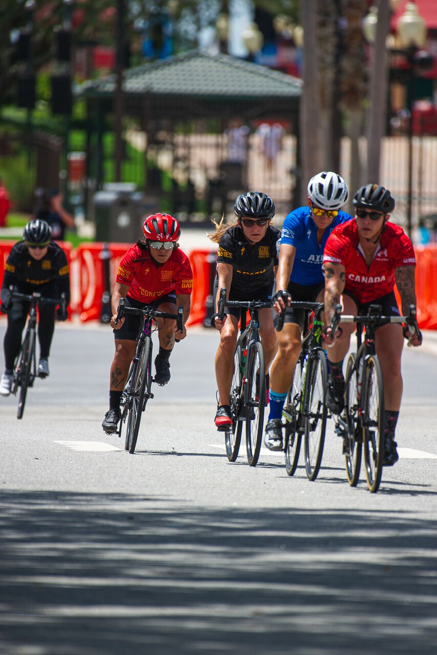 Athletes ride bikes on a road.