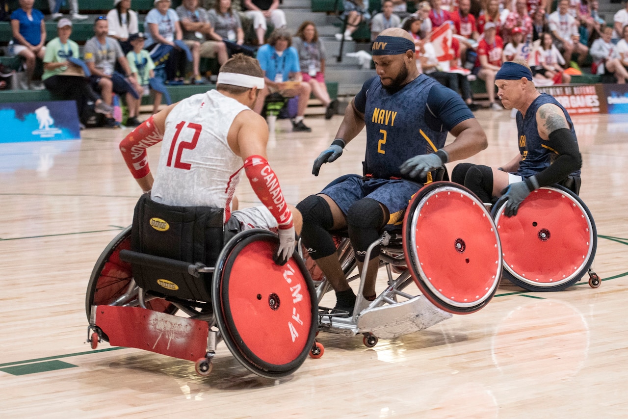 Athletes on a court crash wheelchairs into each other.