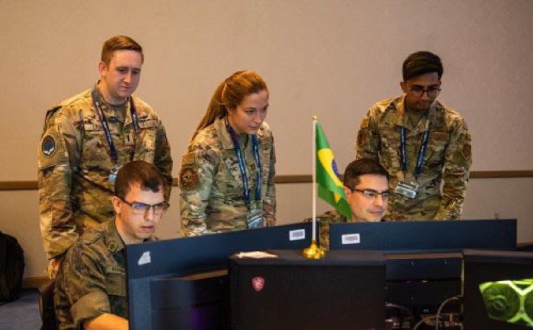 Air Force Capt. Leah Elsbeck, center, and Senior Airman Dhruva Poluru, members of the New York Air National Guard’s 222nd Command and Control Squadron, watch as members of the Brazilian military’s space control team solve a problem during the U.S. Space Command’s Global Sentinel exercise at Vandenberg Space Force Base in July 2022. Elsbeck and Poluru, along with Capt. Victoria Whelan, served as mentors during the exercise.
