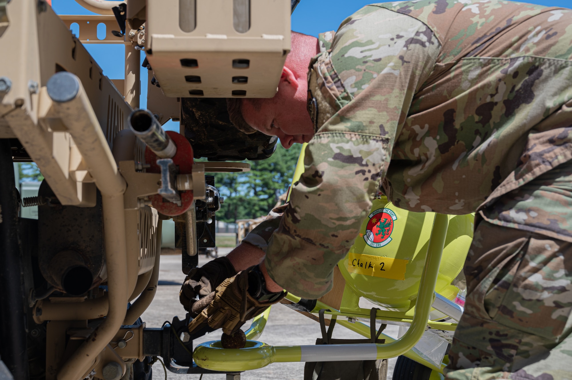 A U.S. Air Force Airman from the 305th Aerial Port Squadron investigates equipment during the Aerial Port of the Future Joint Capability Technology Demonstration on Joint Base McGuire-Dix-Lakehurst, N.J. Aug. 16, 2022. The APoF JCTD improved the way personnel and cargo are processed and transported by applying new methods and technologies in a simulated deployment environment. (U.S. Air Force photo by Airman Simonne Barker)