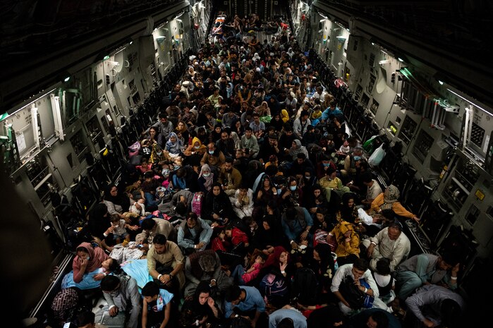 Afghan citizens rest in a U.S. Air Force C-17 Globemaster III after being evacuated from Hamid Karzai International Airport in Kabul, Afghanistan, Aug. 19, 2021. The U.S. Air Force conducted airlift operations to transport approximately 124,000 people from Kabul as part Operation Allies Refuge. The operation was one of the largest air evacuations of civilians in American history. (U.S. Air Force photo by Staff Sgt. Brandon Cribelar)