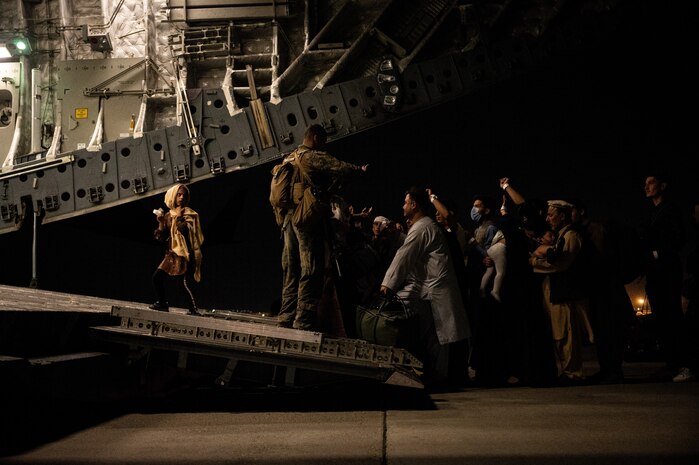 An Afghan child walks up the ramp of a U.S. Air Force C-17 Globemaster III at Hamid Karzai International Airport in Kabul, Afghanistan, during Operation Allies Refuge, Aug. 19, 2021. Approximately 124,000 Afghan citizens were evacuated from Kabul, Afghanistan, during OAR, one of the largest air evacuations of civilians in American history. (U.S. Air Force photo by Staff Sgt. Brandon Cribelar)