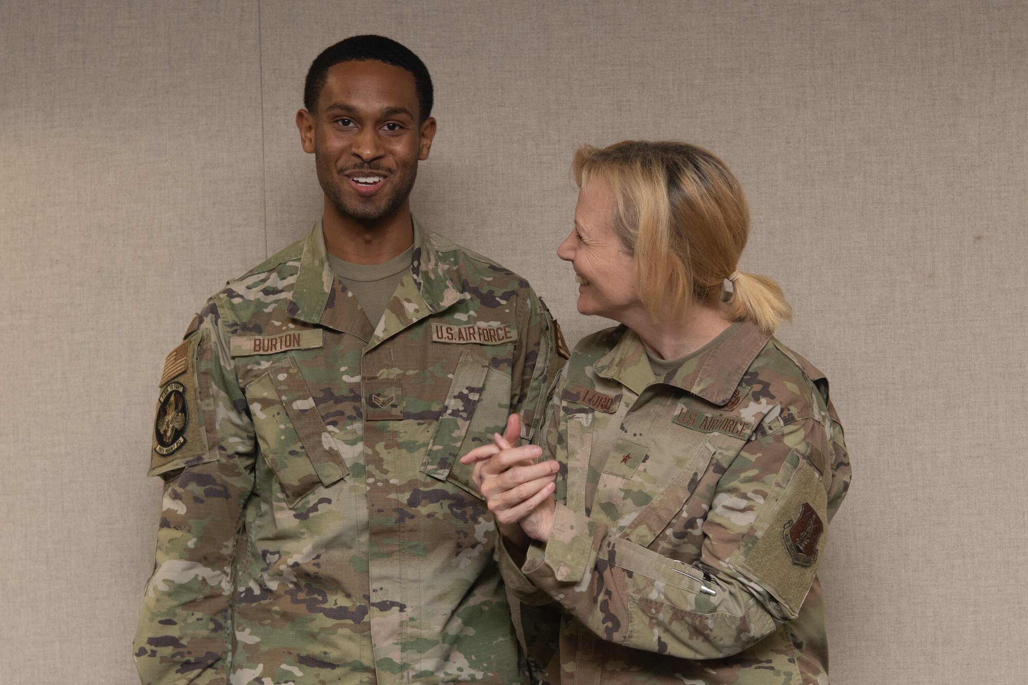 Two Airmen pose for a photo.