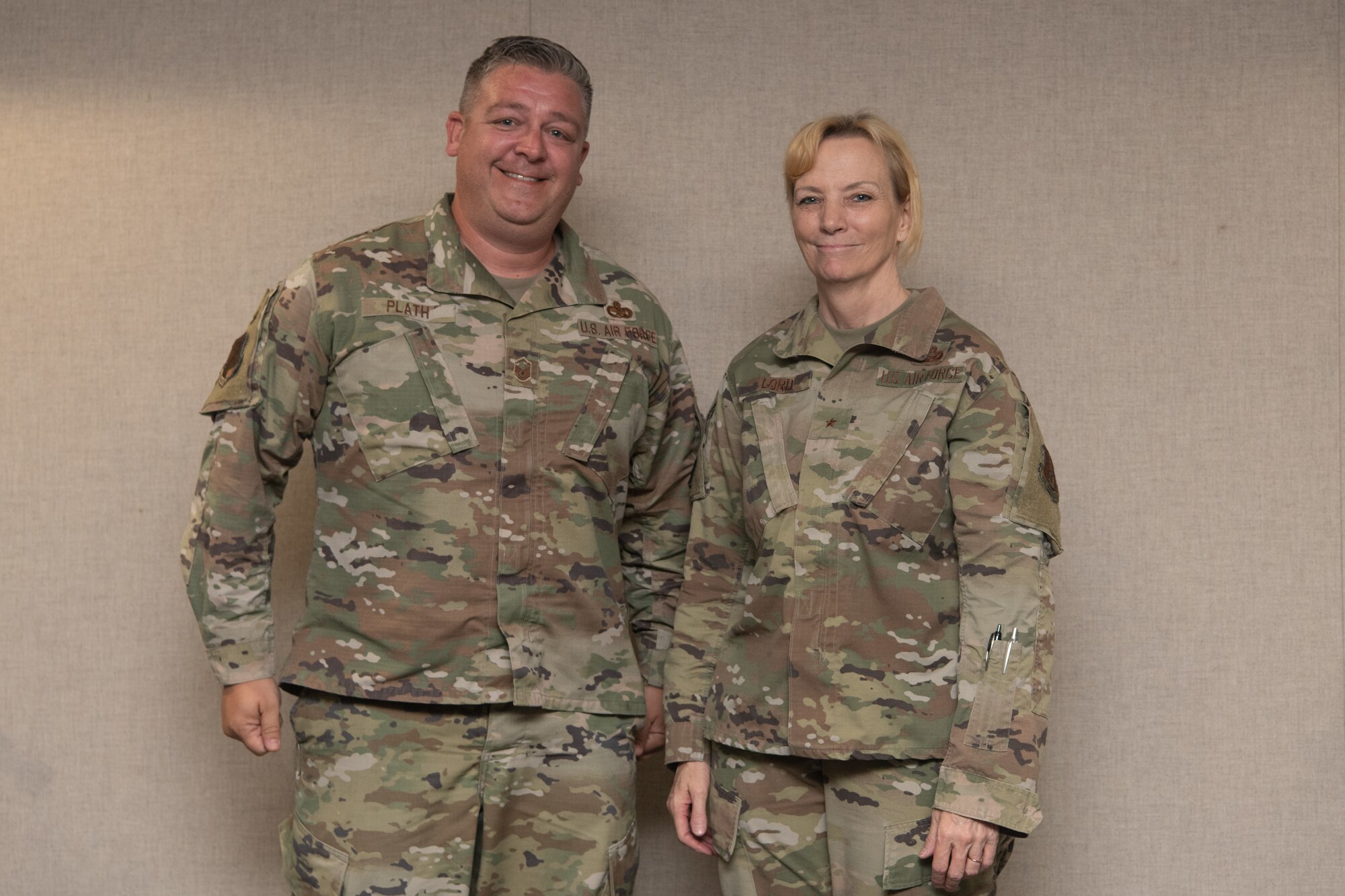 Two Airmen pose for a photo.