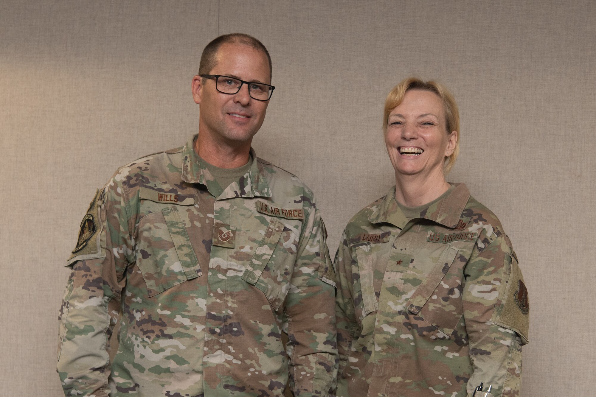 Two Airmen pose for a photo.