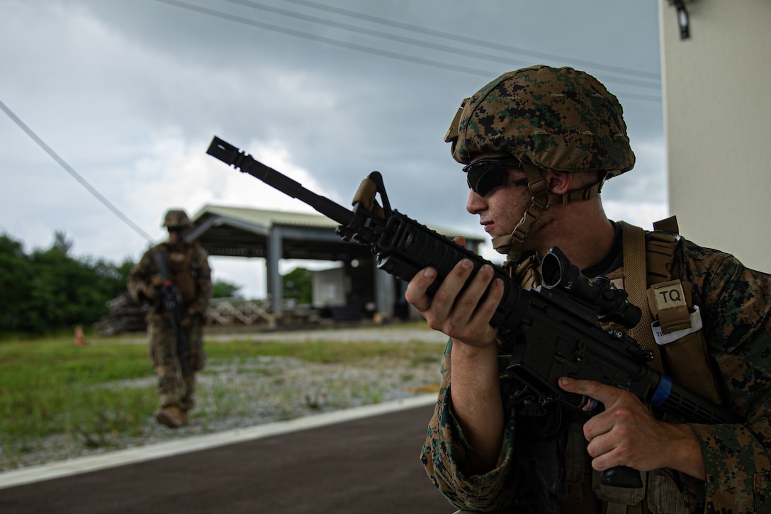U.S. Marine Corps Lance Cpl. Joseph James, an engineer equipment operator with 3rd Landing Support Battalion, Combat Logistics Regiment 3, 3rd Marine Logistics Group, conducts a building clearing drill at Military Operations in Urban Terrain Town, Eastern Training Area, Okinawa, Japan, July 19, 2022. 3rd MLG, based out of Okinawa, Japan, is a forward-deployed combat unit that serves as III MEF’s comprehensive logistics and combat service support backbone for operations throughout the Indo-Pacific area of responsibility. (U.S. Marine Corps photo by Lance Cpl. Weston Brown)