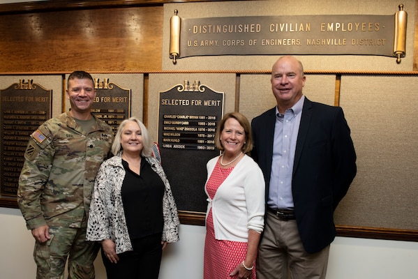 Lt. Col. Joseph Sahl, U.S. Army Corps of Engineers Nashville District commander; and Stephanie Hall (Second from Left), Nashville District deputy district engineer; pose Aug. 24, 2022, with Retiree Linda Adcock and her husband Ricky after unveiling a nameplate honoring Adcock as a recipient of the 2022 Nashville District Distinguished Civilian Employee Recognition Award at the headquarters in Nashville, Tennessee. (USACE Photo by Lee Roberts)