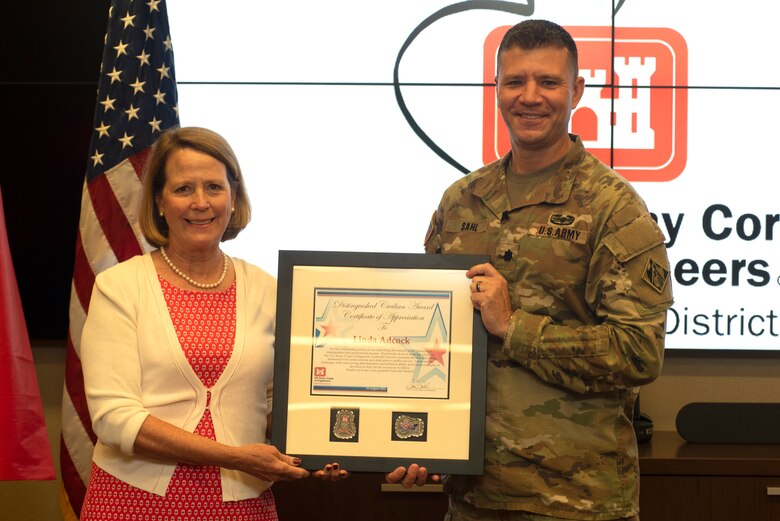 LLt. Col. Joseph Sahl, U.S. Army Corps of Engineers Nashville District commander, presents Retiree Linda Adcock the 2022 Nashville District Distinguished Civilian Employee Recognition Award during a ceremony Aug. 24, 2022, at the headquarters in Nashville, Tennessee. (USACE Photo by Lee Roberts)