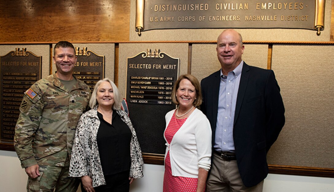 Lt. Col. Joseph Sahl, U.S. Army Corps of Engineers Nashville District commander; and Stephanie Hall (Second from Left), Nashville District deputy district engineer; pose Aug. 24, 2022, with Retiree Linda Adcock and her husband Ricky after unveiling a nameplate honoring Adcock as a recipient of the 2022 Nashville District Distinguished Civilian Employee Recognition Award at the headquarters in Nashville, Tennessee. (USACE Photo by Lee Roberts)