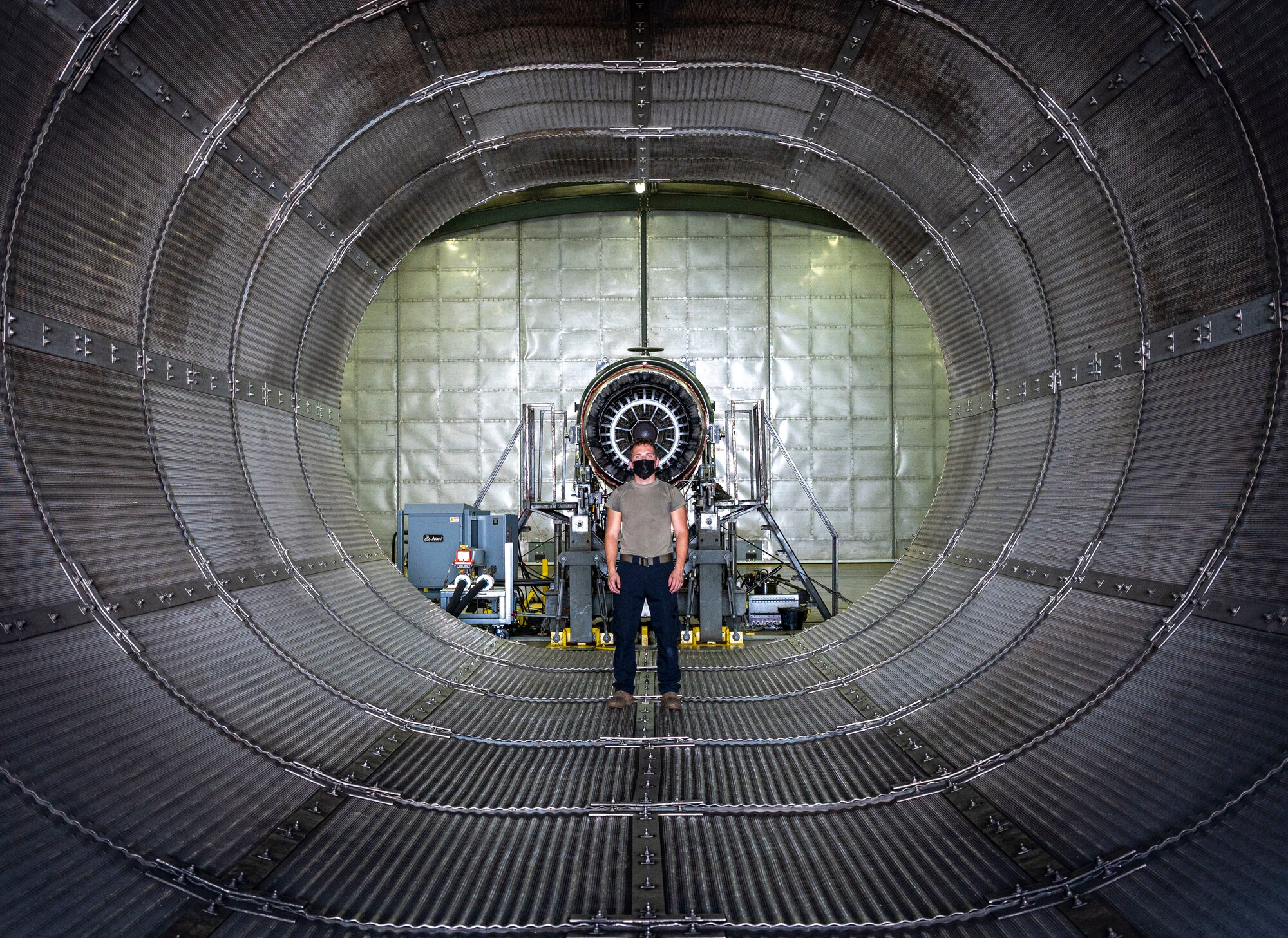 Airman 1st Class Noah Mercer, 4th Component Maintenance Squadron aerospace propulsion technician, stands inside the engine test cell at Seymour Johnson Air Force Base, North Carolina, August 10, 2022. The engine test cell is a specialized hangar used to simulate aircraft fire and test the F-15E Strike Eagle engine throttle. (U.S. Air Force photo by Airman 1st Class Sabrina Fuller)