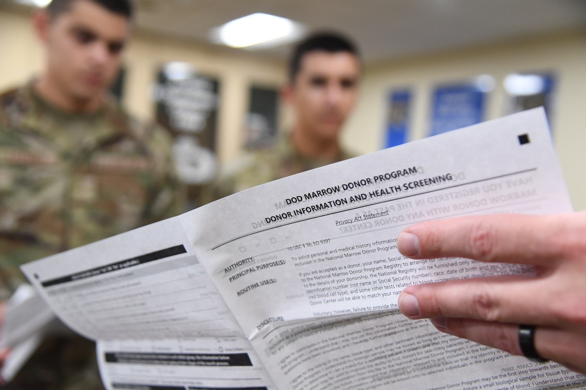 U.S. Air Force Master Sgt. Tanner Thompson, 333rd Training Squadron operations superintendent, explains the registration process to 334th Training Squadron Airmen during a bone marrow donor registration drive inside Cody Hall at Keesler Air Force Base, Mississippi, Aug. 23, 2022. The 81st Training Group partnered with Second Air Force and the Salute to Life program to host the drive throughout the week at the various training squadrons. (U.S. Air Force photo by Kemberly Groue)