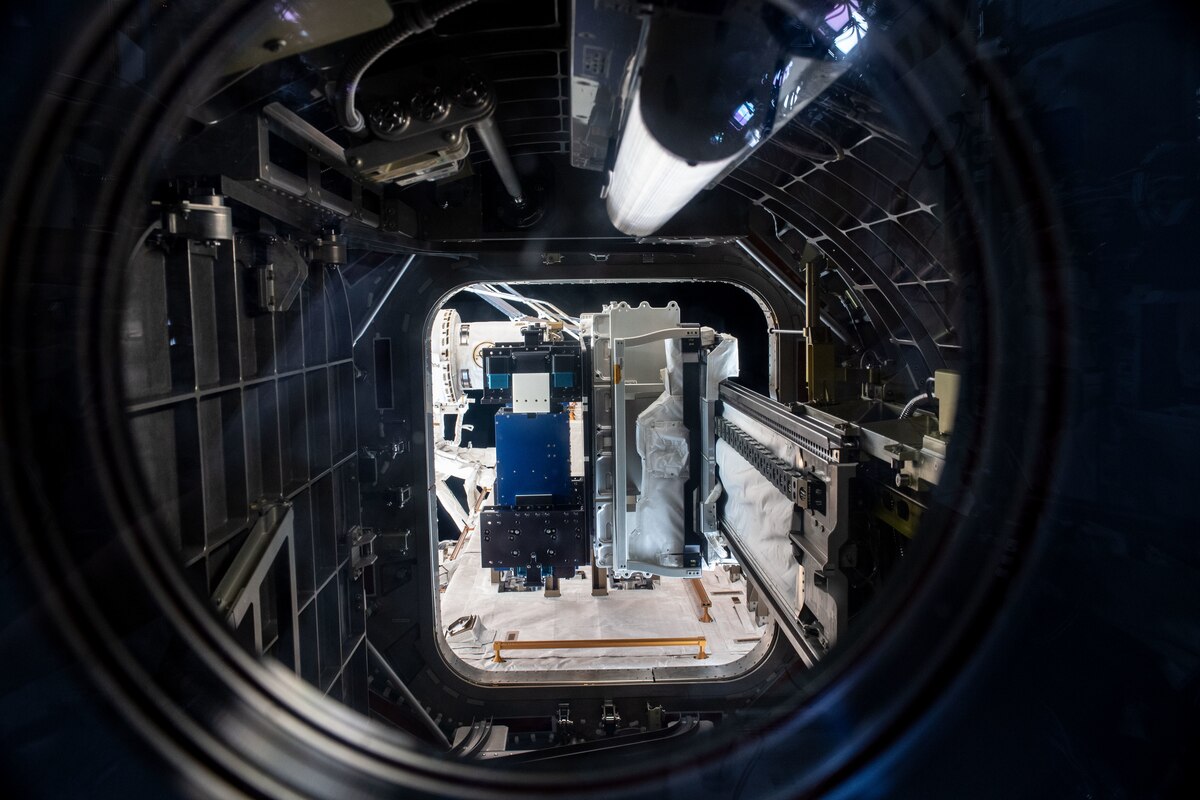 Materials International Space Station Experiment, or MISSE, shown in the blue panel on the airlock slide tray, at the International Space Station, as the Special Purpose Dexterous Manipulator grapples it. The MISSE space flight experiment is a collaboration among the Air Force Research Laboratory, NASA, Georgia Tech Research Institute and DuPont to study the effects of space weather on spacecraft materials. (Photo credit / NASA)