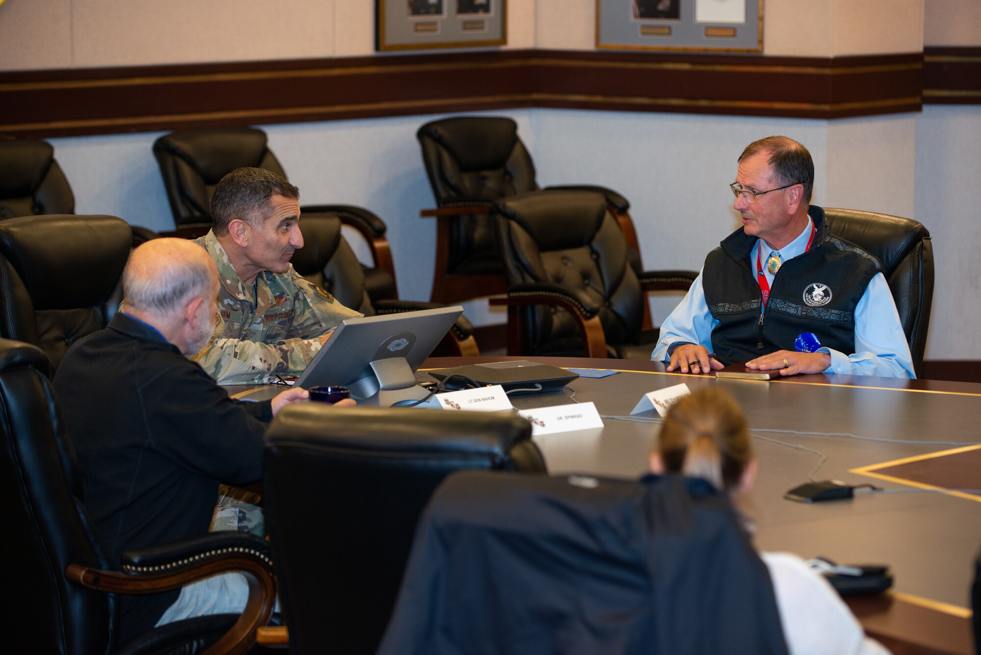 Photo of Dr. Richard “Rick” Spinrad, U.S. Air Force Lt. Gen. David Nahom, retired U.S. Air Force Maj. Gen. Randy “Church” Kee, and U.S. Coast Guard Capt. Leanne Lusk sitting at a conference table and holding a discussion.