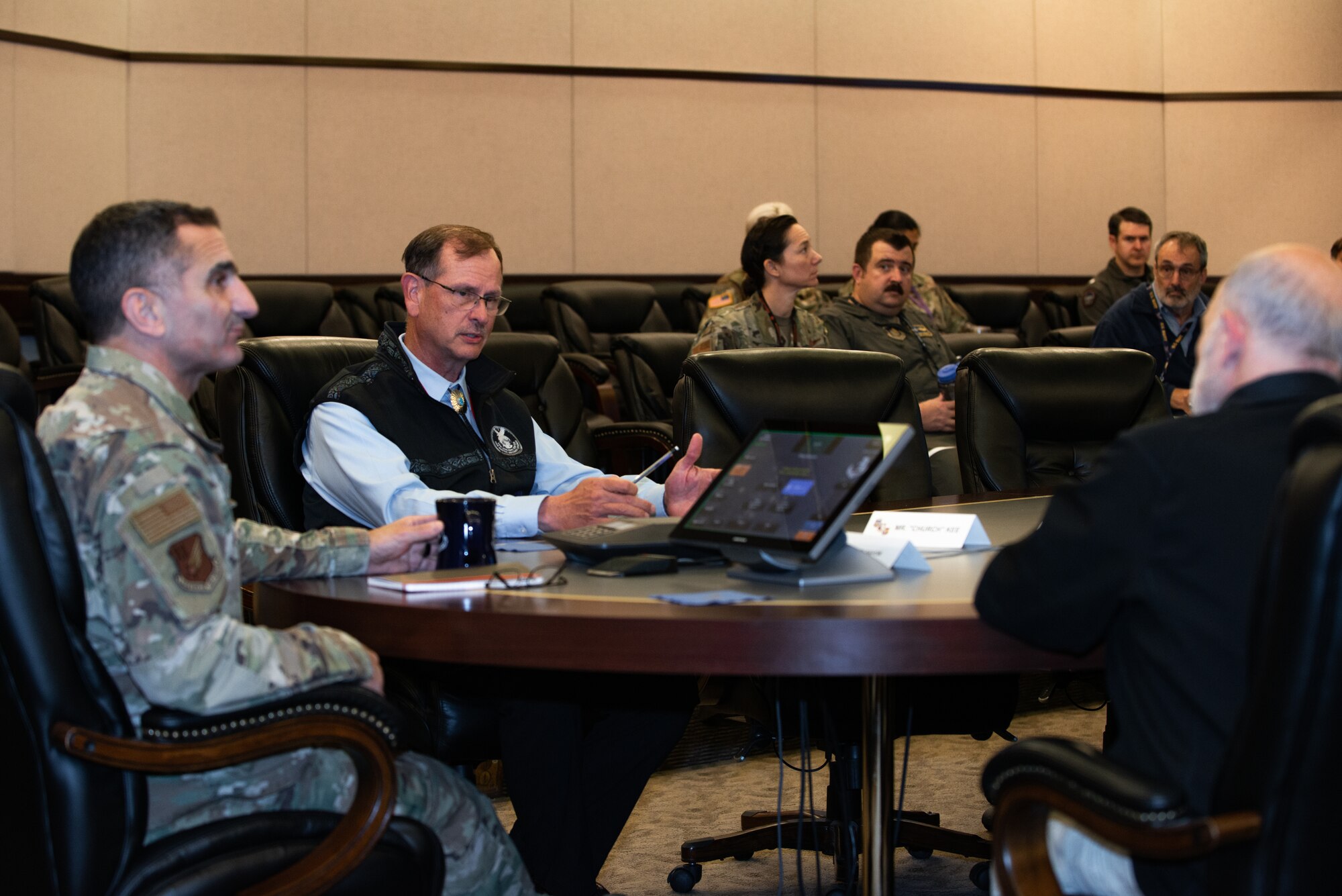 Photo of Dr. Richard “Rick” Spinrad, U.S. Air Force Lt. Gen. David Nahom, and retired U.S. Air Force Maj. Gen. Randy “Church” Kee sitting at a conference table and holding a discussion.