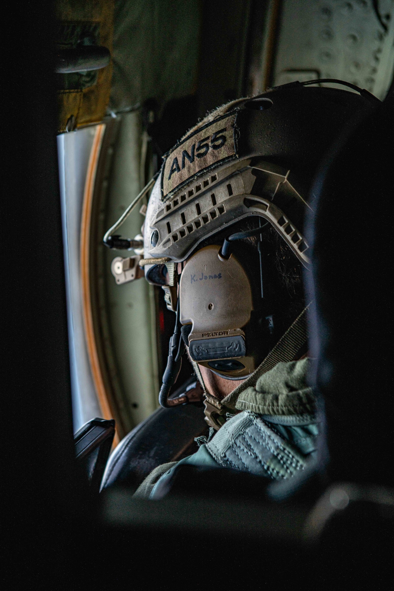 An Airman stares out the window towards the ocean