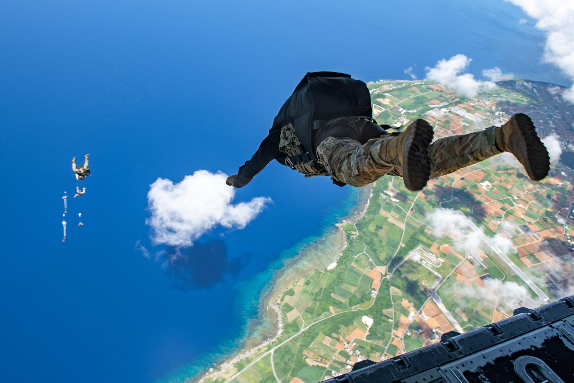 A Navy member jumps after his buddies from a plane over the coast of Japan.