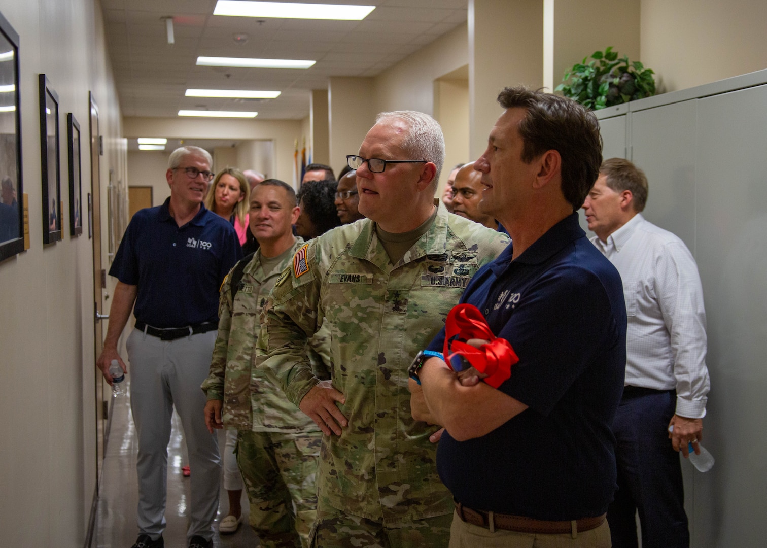 U.S. Army Lt. Gen. John R. Evans, U.S. Army North commanding general, Command Sgt. Maj. Phil K. Barretto, senior enlisted advisor, cut the ribbon with Wayne Peacock, president and chief executive of USAA, to celebrate the relationship with USAA and the U.S. Army at Building 44 on Joint-Base San Antonio-Fort Sam Houston, Texas, Aug.18, 2022. The ceremony honored USAA’s historical roots among the local San Antonio, Texas community and celebrated the long-standing partnership with U.S. Army North in connection to the building. (U.S. Army photo by Pfc. Gianna Elle Sulger)