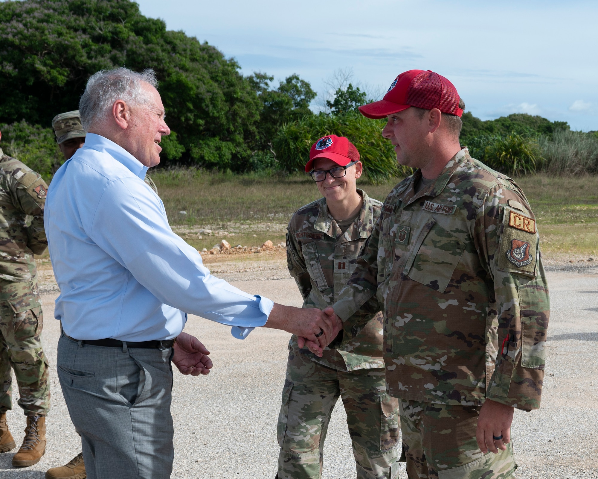 Secretary of the Air Force Frank Kendall coins Master Sgt. Ryan Maxwell, 554th RED HORSE materiel management section chief, during his visit to Andersen Air Force Base, Guam, Aug. 19, 2022.
