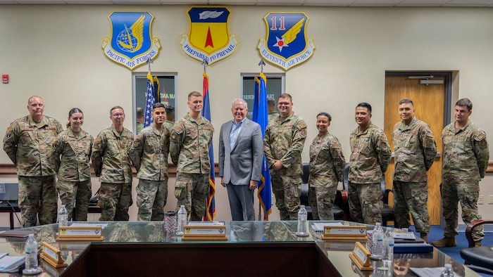 Secretary of the Air Force Frank Kendall and Airmen pose for a group photo during his visit to Andersen Air Force Base, Guam, Aug.19, 2022.
