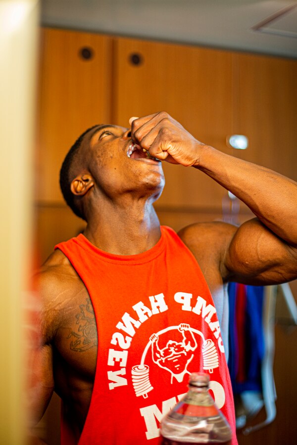 U.S. Marine Corps Cpl. Jason Joseph, a military police officer with Provost Marshal’s Office, Headquarters and Support Battalion, Marine Corps Installations Pacific, takes Vitamin C on Marine Corps Air Station Futenma, Okinawa, Japan, July 12, 2022. Joseph began his bodybuilding journey in 2022 and has competed in two bodybuilding competitions, earning him a second and third place medal in each respectively, and aims to become an International Federation of Bodybuilding and Fitness Professional. (U.S. Marine Corps photo by Cpl. Alex Fairchild)