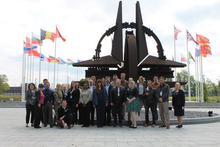 Dylan Sweem, the installation transportation officer at Logistics Readiness Center Benelux in Brussels (sixth from left), poses for a photo with members of his team and their primary customer base at NATO headquarters who they support. Sweem said he’s been working for four years in what can only be described as a multicultural, multinational melting pot. (Courtesy photo)
