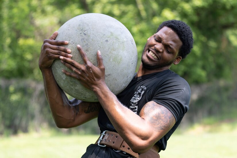 Soldier carries a large stone