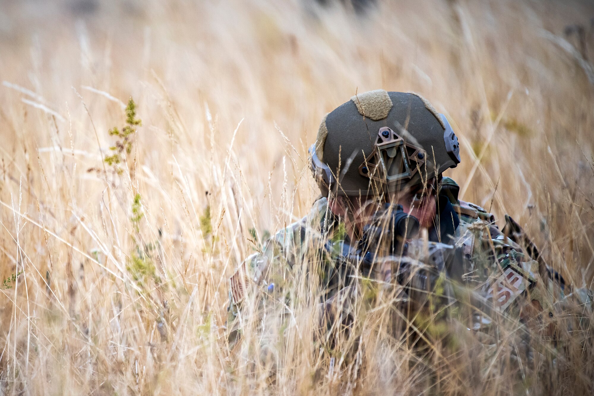 U.S. Air Force Airman 1st Class Richard Maria Perez, 423d Security Forces Squadron flight member, lays prone while looking down the sight of an M4 carbine during a Field Training exercise at Stanford Training Area, England, Aug. 17, 2022. Instructors from the 820th Base Defense Group and 435th Security Forces Squadron Ground Combat Readiness Training Center, conducted the exercise to evaluate and bolster the combat readiness skills of the defenders from the 423d SFS. (U.S. Air Force photo by Staff Sgt. Eugene Oliver)