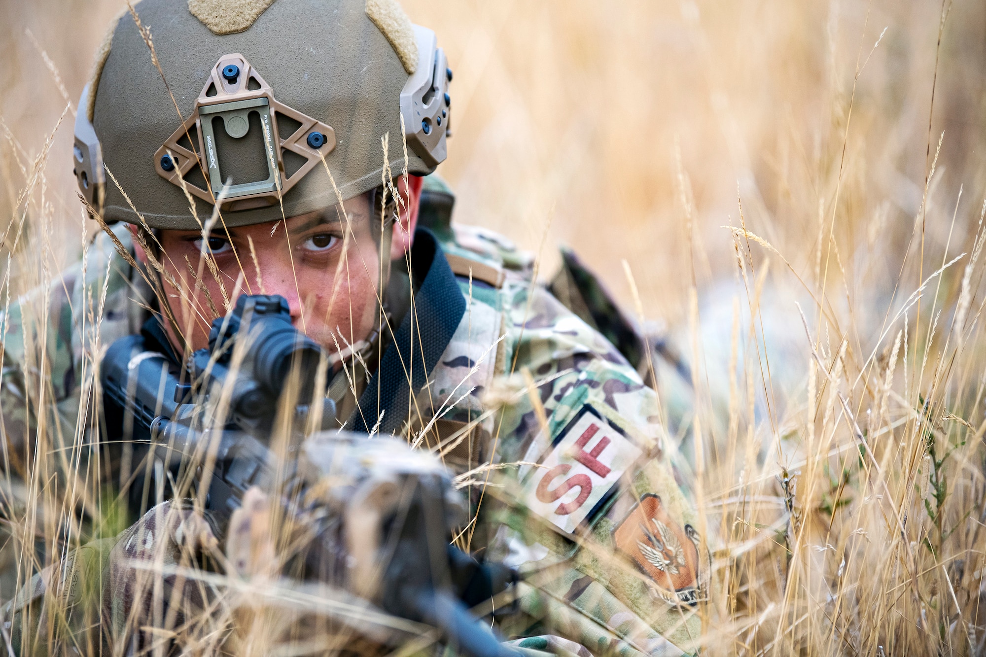 U.S. Air Force Airman 1st Class Richard Maria Perez, 423d Security Forces Squadron flight member, lays prone while looking down the sight of an M4 carbine during a Field Training exercise at Stanford Training Area, England, Aug. 17, 2022. Instructors from the 820th Base Defense Group and 435th Security Forces Squadron Ground Combat Readiness Training Center, conducted the exercise to evaluate and bolster the combat readiness skills of the defenders from the 423d SFS. (U.S. Air Force photo by Staff Sgt. Eugene Oliver)