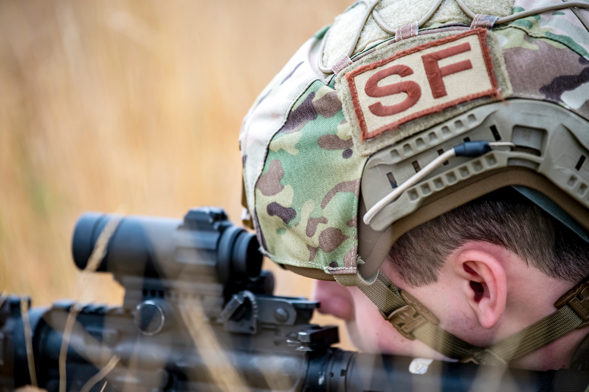 An Airman from the 423d Security Forces Squadron looks down the sight of an M4 carbine during a field training exercise at Stanford Training Area, England, Aug. 17, 2022. Instructors from the 820th Base Defense Group and 435th Security Forces Squadron Ground Combat Readiness Training Center, conducted the exercise to evaluate and bolster the combat readiness skills of the defenders from the 423d SFS. (U.S. Air Force photo by Staff Sgt. Eugene Oliver)